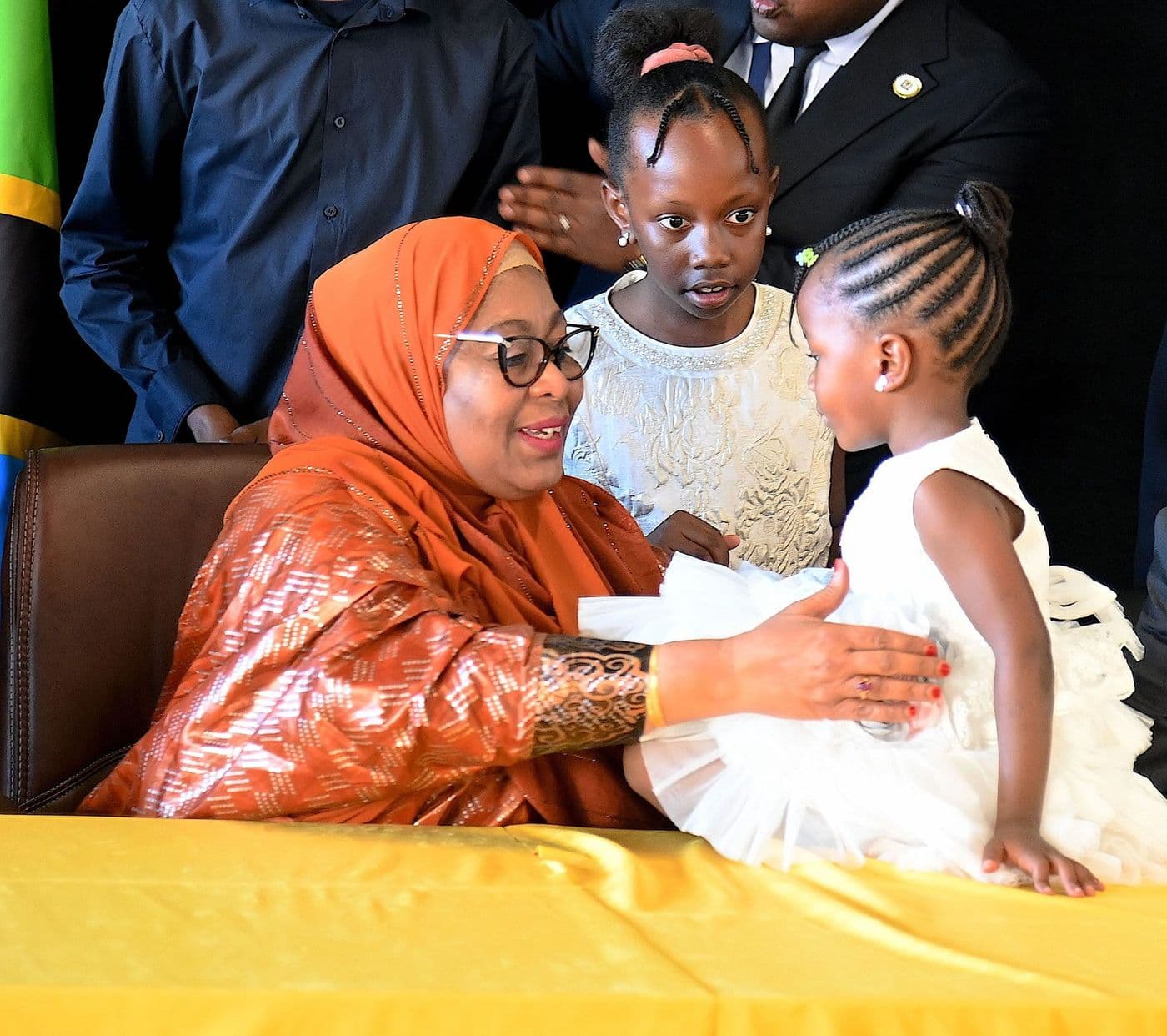 The President greeting two young girls at a public ceremony